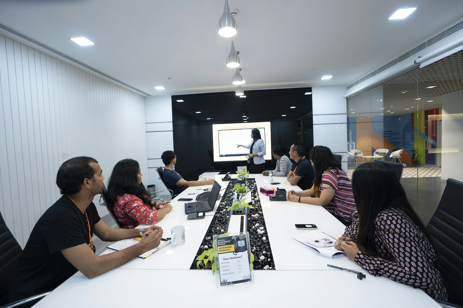 Team members attending a presentation in a meeting room