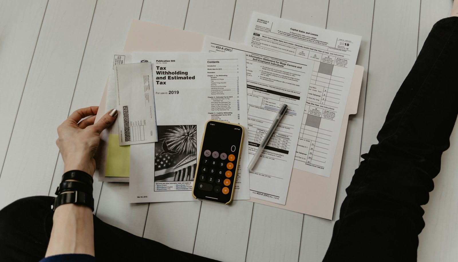 Financial documents reviewed with a calculator