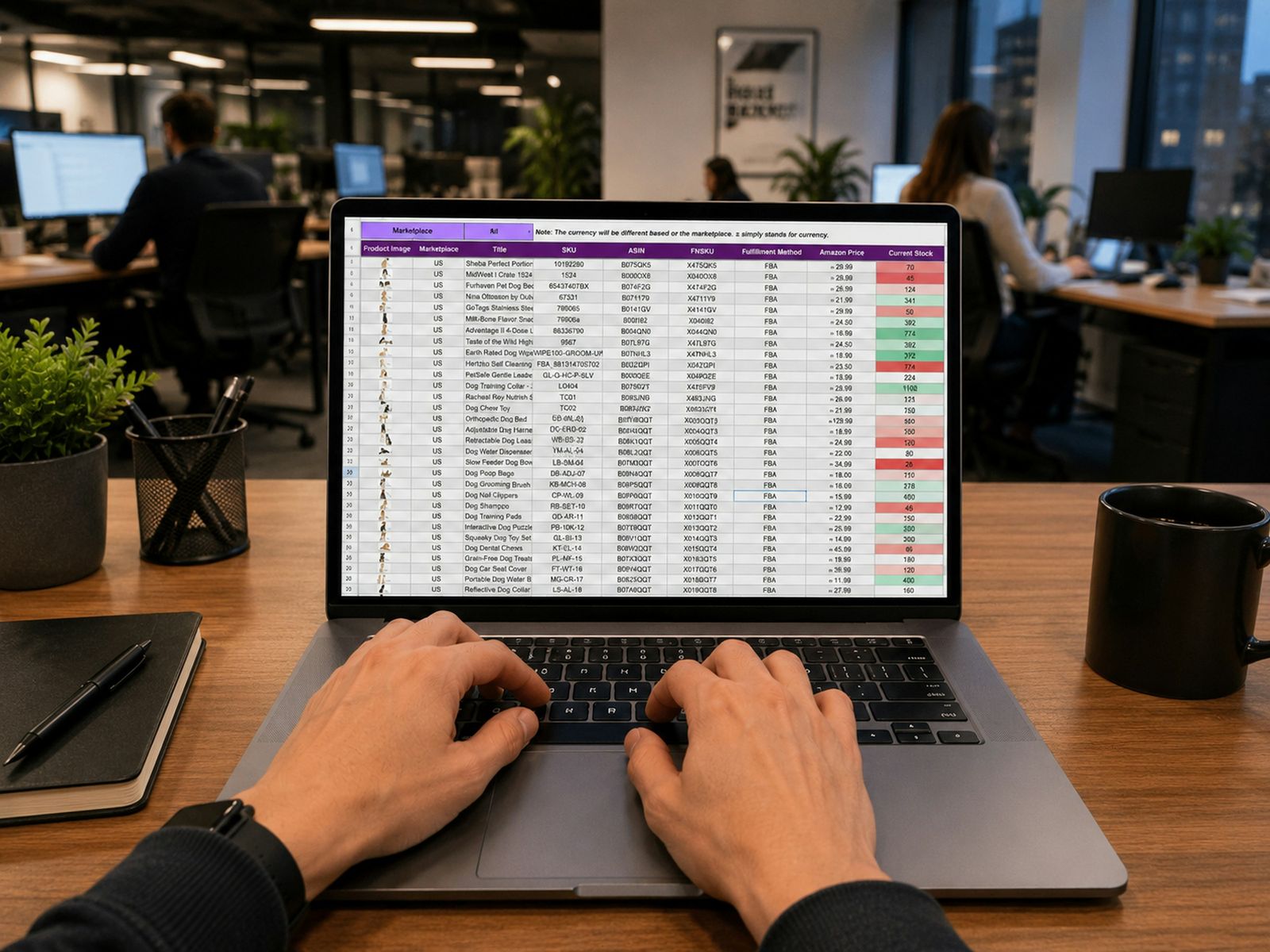Hands typing on a laptop showing a data spreadsheet