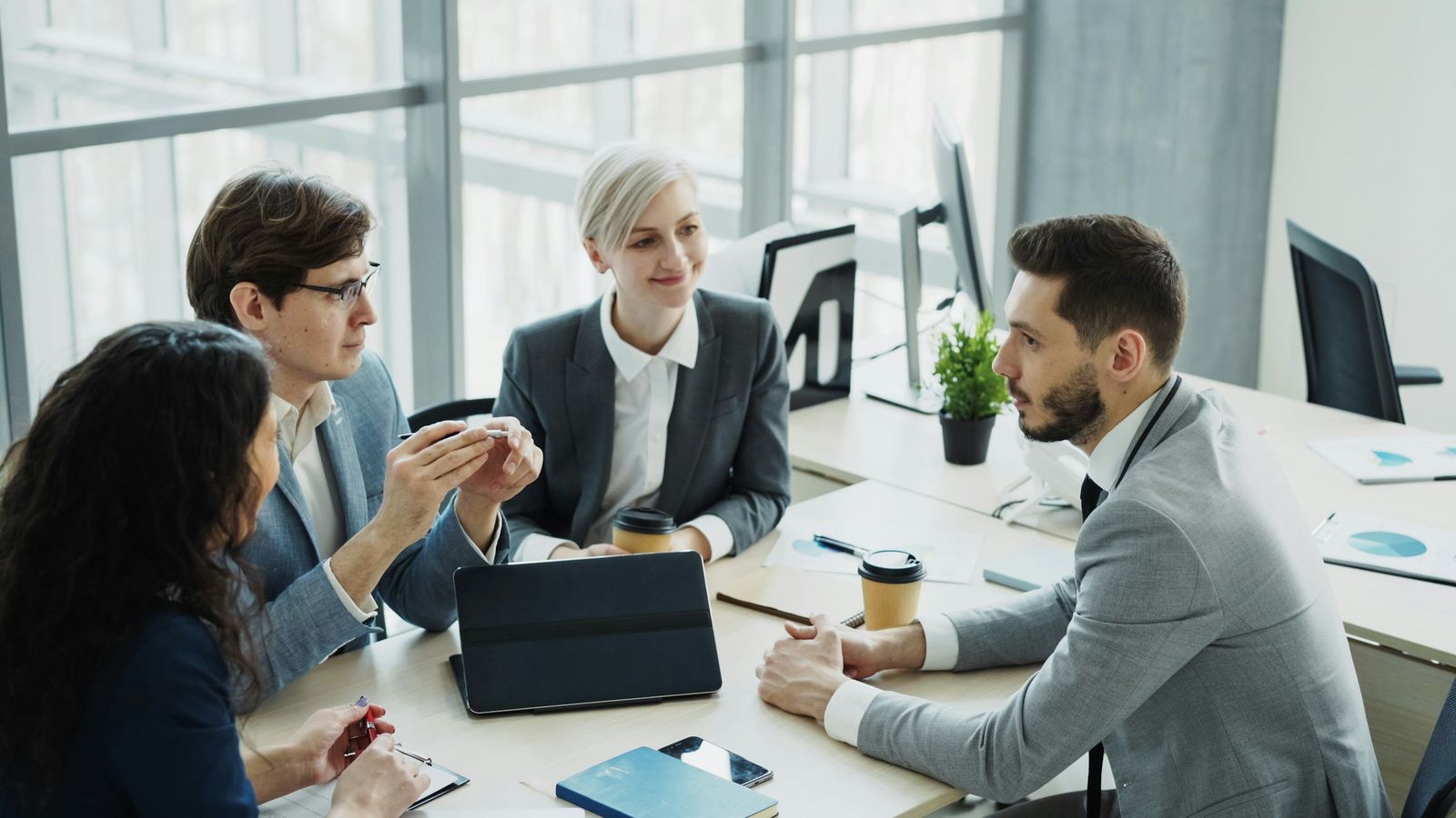 Professionals discussing a case around a meeting table